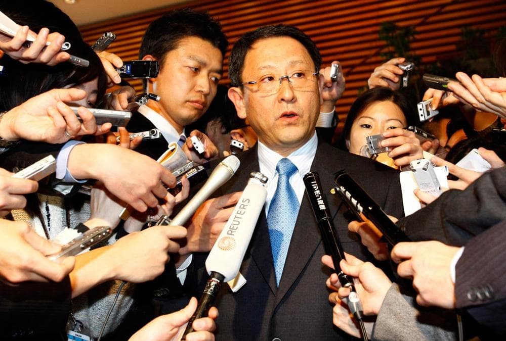 Toyota President Akio Toyoda, center, answers reporters&#39; questions after a meeting with Japanese Prime Minister Yukio Hatoyama in Tokyo on Monday. (AP)
