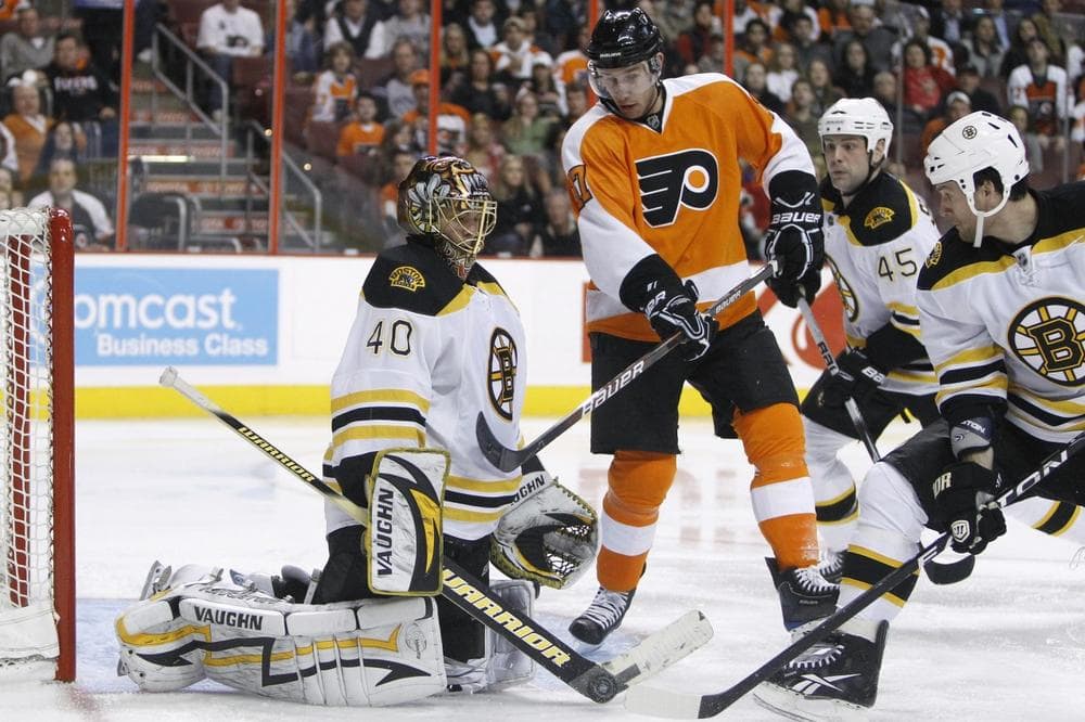 Philadelphia Flyers' Jeff Carter, center, has his shot blocked by Boston Bruins goalie Tuukka Rask, from left, as Mark Stuart and Dennis Wideman look on in the second period of Thursday night's game. (AP)