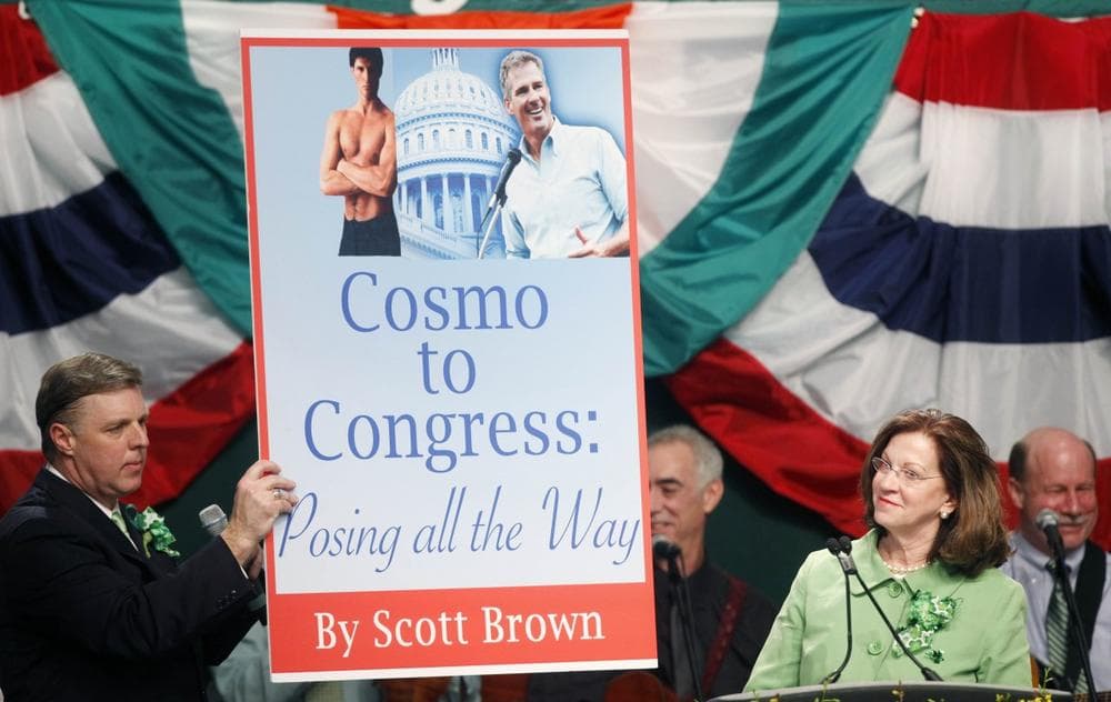 State Sen. Jack Hart holds up a mock book cover brought to the stage by Massachusetts Senate President Therese Murray, right. (AP)