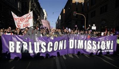 Purple People demonstrators in Rome last year carry a banner demanding the resignation of Italian premier Silvio Berlusconi (AP) 