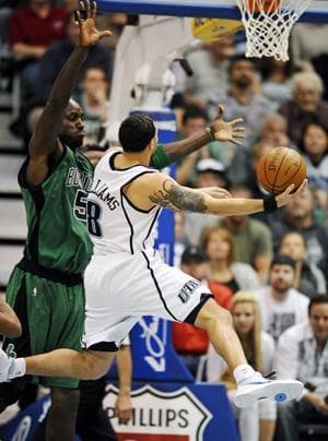 Jazz guard Deron Williams drives to the basket as Celtics forward Kevin Garnett defends during Monday&#39;s game. (AP)