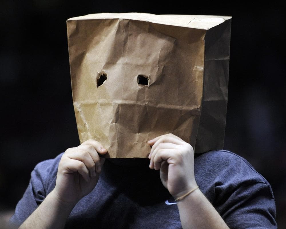 A fan with a paper bag over his head watches during an NBA basketball game between the New Jersey Nets and the Miami Heat on March 22 in East Rutherford, N.J. (AP)