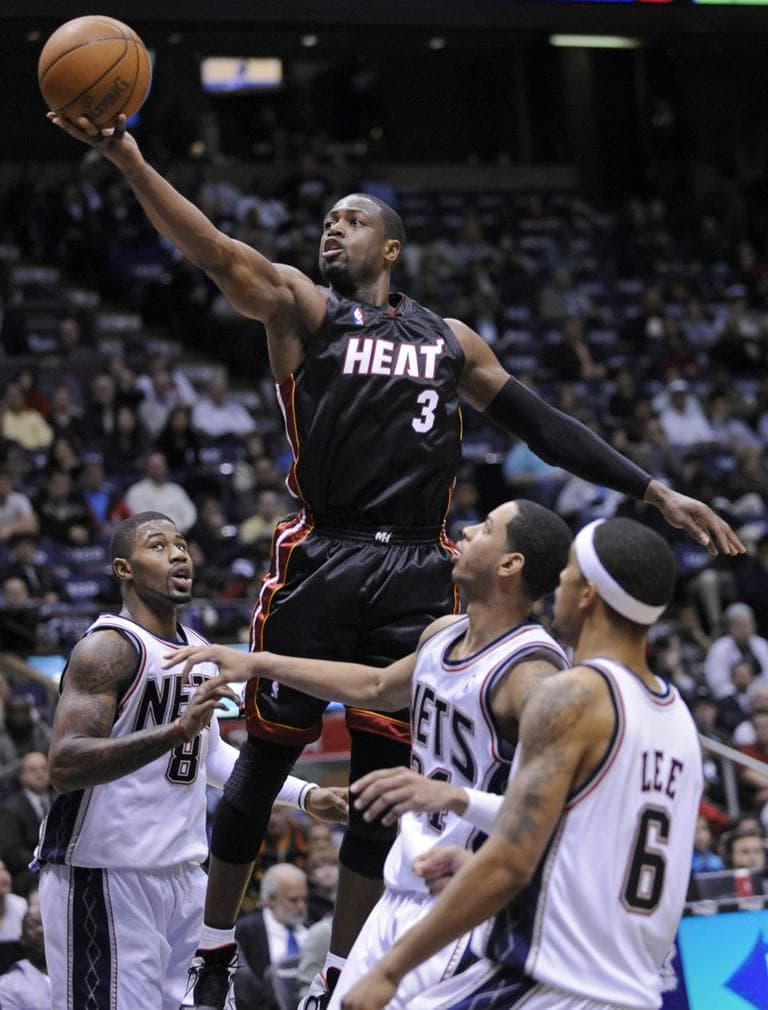 Rising easily over the Nets, the Miami Heat&#39;s Dwyane Wade puts up a shot. (AP)