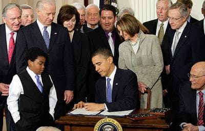 President Obama signs his landmark health care reform bill into law (AP)