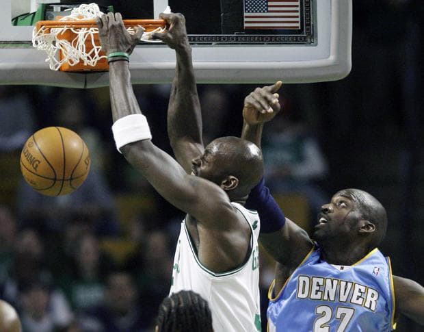 Celtics&#39; Kevin Garnett dunks against Nuggets&#39; Johan Petro during Wednesday&#39;s game in Boston. (AP)