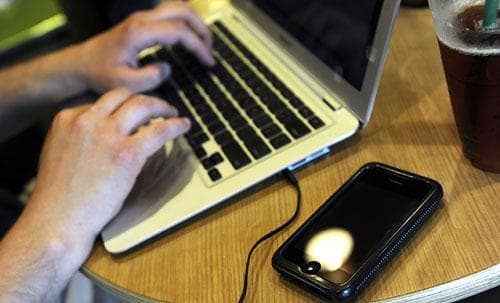 A laptop and iPhone at a coffee shop in Columbia, Mo., in a 2009 photo. (AP)