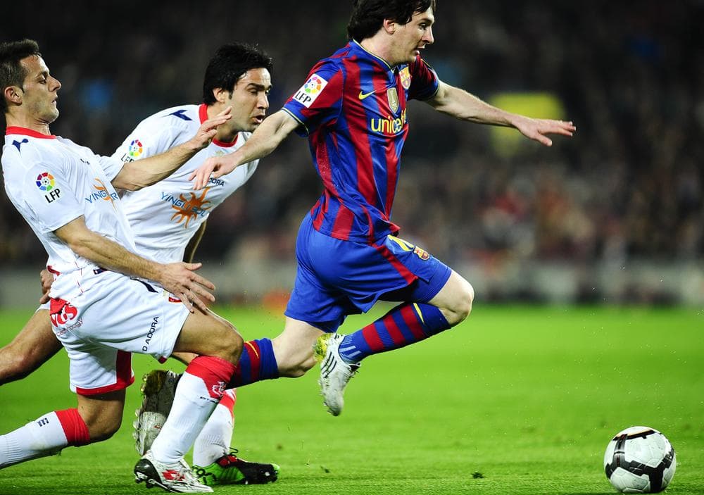 FC Barcelona&#039;s Lionel Messi from Argentina (right), duels for the ball in a match against Osasuna FC in Barcalona. (AP Photo)