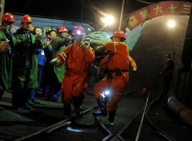 A survivor is rescued out of the flooded Wangjialing Coal Mine in Xiangning, north China's Shanxi Province on Monday. (Xinhua News Agency via AP)
