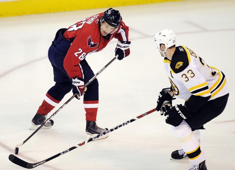 Capitals left wing Alexander Semin, of Russia, battles for the puck against Bruins defenseman Zdeno Chara, of Slovakia, during the second period of the game on Monday  in Washington. (Nick Wass/AP)
