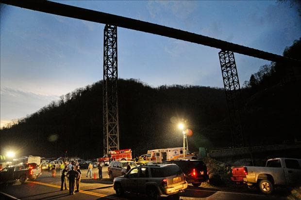 West Virginia State Police direct traffic at the entrance to Massey Energy's Upper Big Branch Coal Mine on Monday.  (Jeff Gentner/AP)