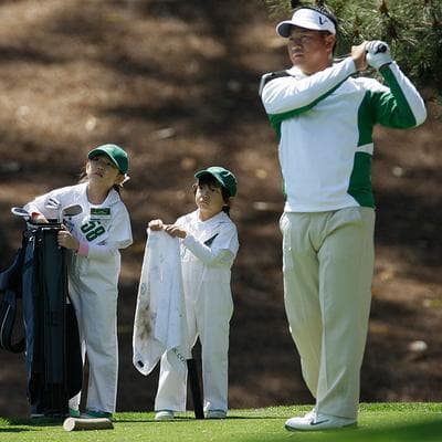 K.J. Choi&#39;s son, Daniel, and daughter, Amanda, watch their father&#39;s tee shot during the Par 3 contest before the Masters golf tournament in Augusta, Ga., on Wednesday. (AP)