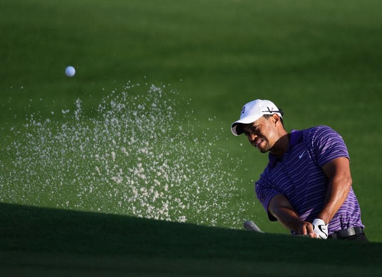 Tiger Woods chips out of a trap on the second hole during a practice round at the Masters golf tournament in Augusta, Ga. (AP)