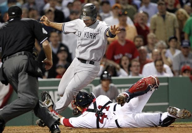 Boston catcher Victor Martinez stretches but cannot tag out Yankees' Jorge Posada in the seventh inning in a game at Fenway Park in Boston on Wednesday. (AP)