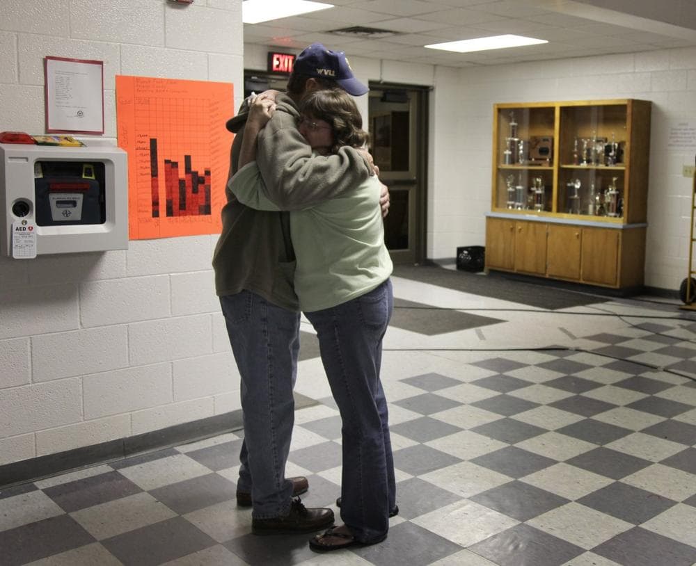 Tammy Gobble is embraced by her father Charles Dickens after hearing the news that rescue workers located the bodies of four missing miners deep in a West Virginia coal mine early Saturday morning in Montcoal W.Va. .  (AP Photo/Amy Sancetta)