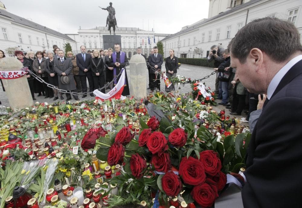 Staff of the Presidential Palace, background, hold a prayer in Warsaw, Poland, Saturday as news broke out about Polish President's Lech Kaczynski death. (AP Photo/Czarek Sokolowski)