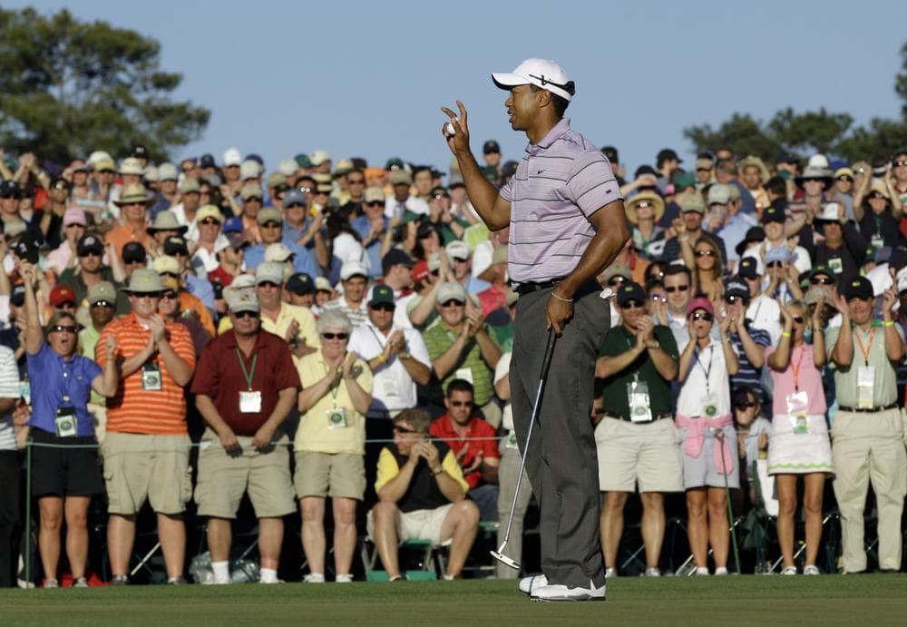 Tiger Woods waves to spectators on the 18th green after his third round of the Masters golf tournament in Augusta, Ga., Saturday. (AP Photo/David J. Phillip)