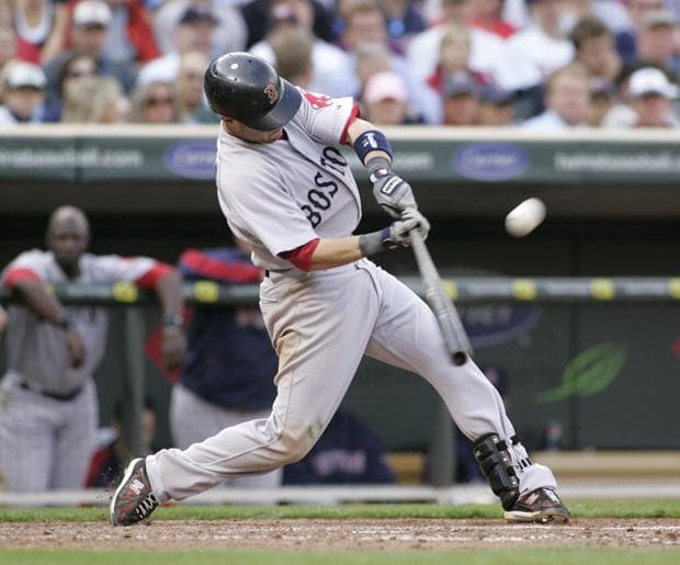 Boston's Dustin Pedroia hits a sacrifice fly scoring teammate  Jeremy Hermida from third during the eighth inning of the game on Monday in Minneapolis. The Twins won 5-2. (AP)