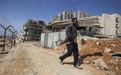 A Palestinian worker constructing homes in Beitar Illit, near Jerusalem. (AP)
