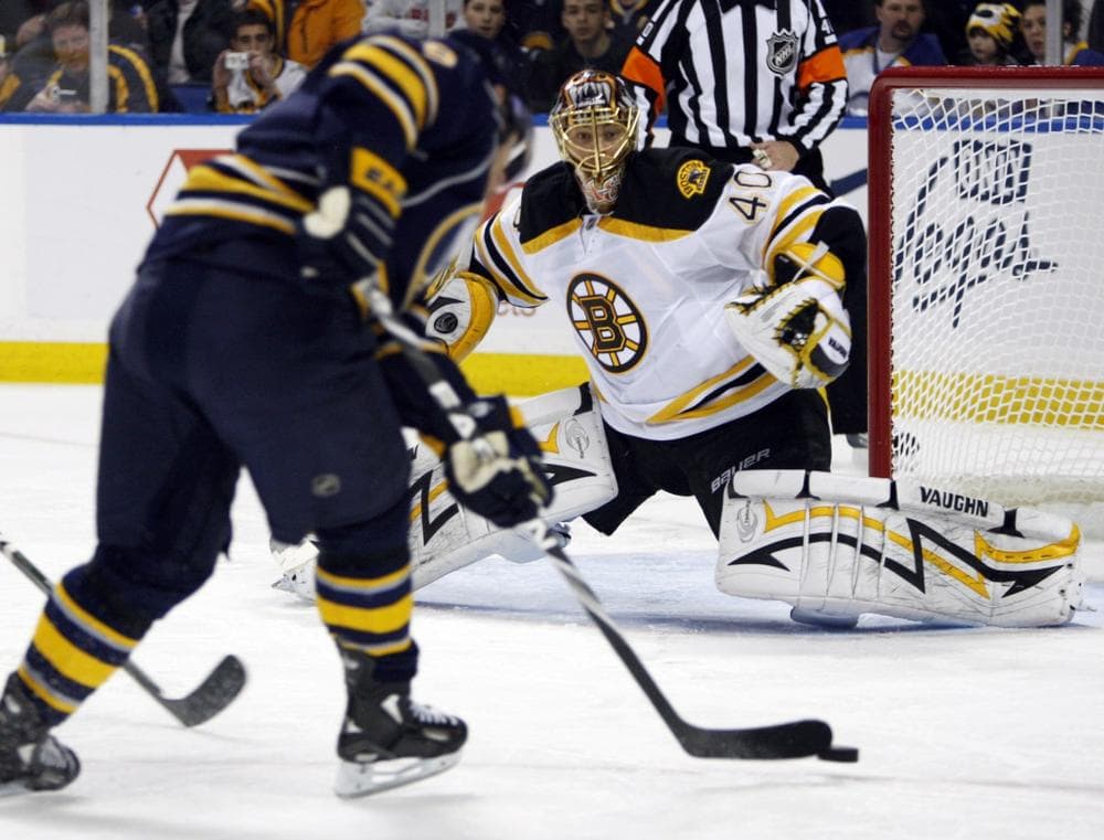Bruins goalie Tuukka Rask, right, makes a save on a shot by Buffalo Sabres' Derek Roy. (AP Photo/ David Duprey) 