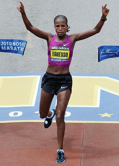 Teyba Erkesso, of Ethiopia, raises her arms as she breaks the finish line tape to win the Boston Marathon women&#39;s race on Monday. (AP) (Click to enlarge)