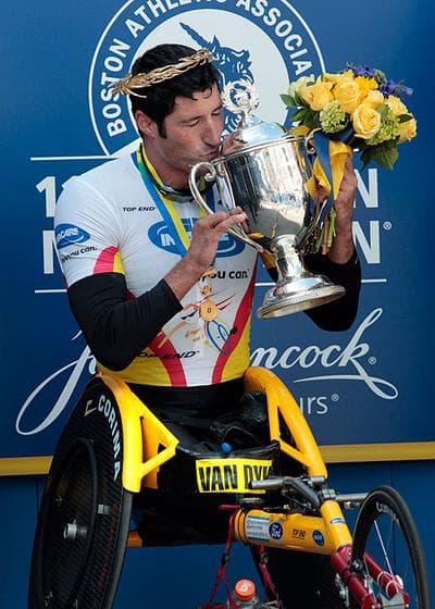 Men&#39;s wheelchair winner Ernst Van Dyk, of South Africa, kisses his trophy after the 114th running of the Boston Marathon on Monday. (AP) (Click to enlarge)