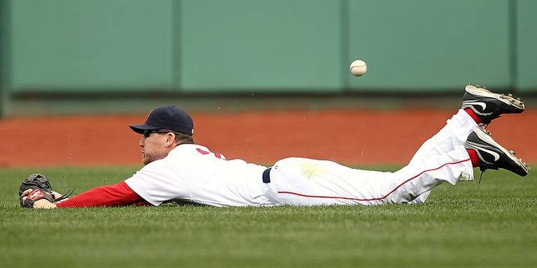 Boston Red Sox right fielder J.D. Drew has the ball get by him after making a diving attempt at a double by Tampa Bay Rays' Reid Brignac during the fourth inning at Fenway Park in Boston on Monday. (AP)