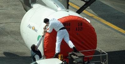 A protective cover is put on the engines of a plane grounded in Milan&#039;s Linate airport, Italy. (AP)