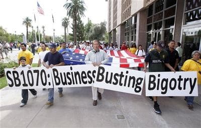Hundreds of protesters rally at the Arizona Capitol to protest the possible signing of immigration bill SB1070 by Gov. Jan Brewer Friday, April 23, 2010, in Phoenix. (AP)