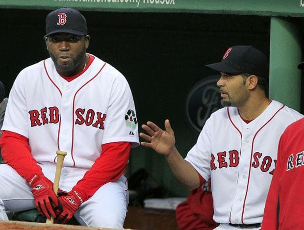 Boston designated hitter David Ortiz sits on the bench and listens to teammate Mike Lowell during the first inning against Texas in the game in Boston on Thursday.(AP)