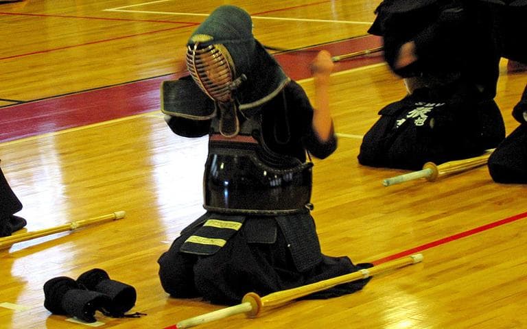 A member of Princeton University’s kendo team prepares for Shoryuhai at Harvard on April 10. (Doug Tribou/WBUR)