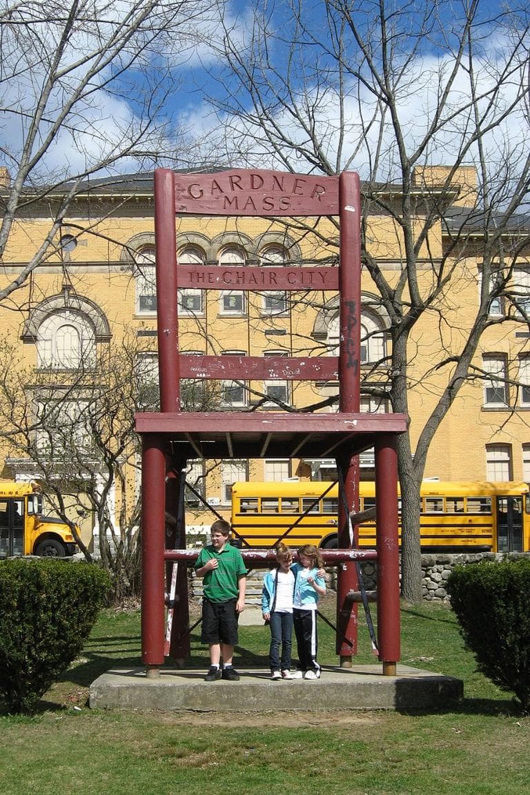 Children gather round 'Chair City&#39;s landmark. (David Boeri/WBUR)
