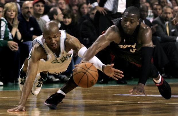 Boston guard Ray Allen and Miami guard Dwyane Wade dive for a loose ball during the first half of a first-round playoff game in Boston on Tuesday. (AP)