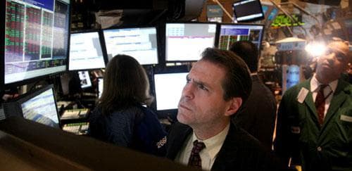 Charles Solomon, a trader with Barclay&#039;s, reviews stock information on a monitor during late trading at the New York Stock Exchange, Thursday March 18, 2010. (AP)