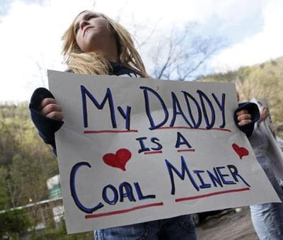 Brianna Bailey, 14, holds a sign showing her support for coal miners near the entrance of the Upper Big Branch Mine, Friday, April 9, 2010, in Montcoal, W. Va. (AP)