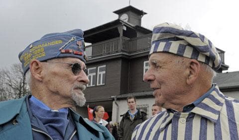 Nazi concentration camp survivor Viktor Savytskyi of Ukraine, right, talks with U.S. army veteran Clarence H. Brockman of Pennsylvania, left, in front of the Buchenwald camp entrance, April 11, 2010, during anniversary ceremonies.