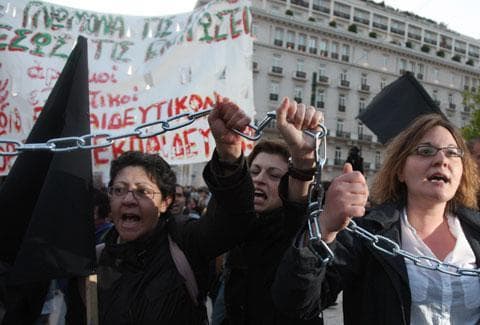 Unemployed school teachers chant slogans at an anti-government demonstration outside the Greek Parliament in Athens, Tuesday, April 27, 2010. Greece&#039;s debt crisis intensified Tuesday as its credit rating was cut to junk status. (AP)