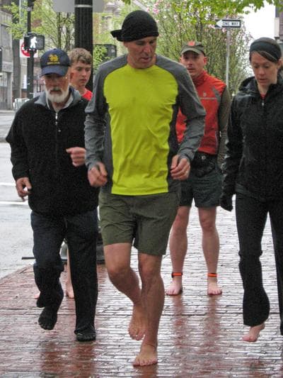 &quot;Born To Run&quot; author Christopher McDougall demonstrates barefoot running to a group in Boston. (Karen Given/WBUR)