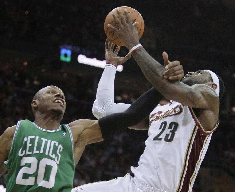 Celtics' Ray Allen (20) fouls Cleveland Cavaliers' LeBron James (23) in the third quarter. (AP Photo/Tony Dejak) 