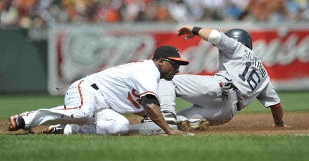 Baltimore third baseman Miguel Tejada tags out Boston's Marco Scutaro on a steal attempt during the first inning of the game Sunday in Baltimore.(AP)