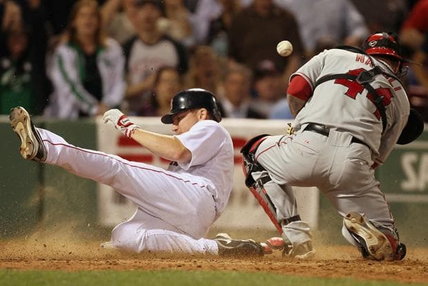 Boston's J.D. Drew slides safely into home as Los Angeles catcher Mike Napoli can't handle the throw during the sixth inning of the game in Boston on Monday. (AP)