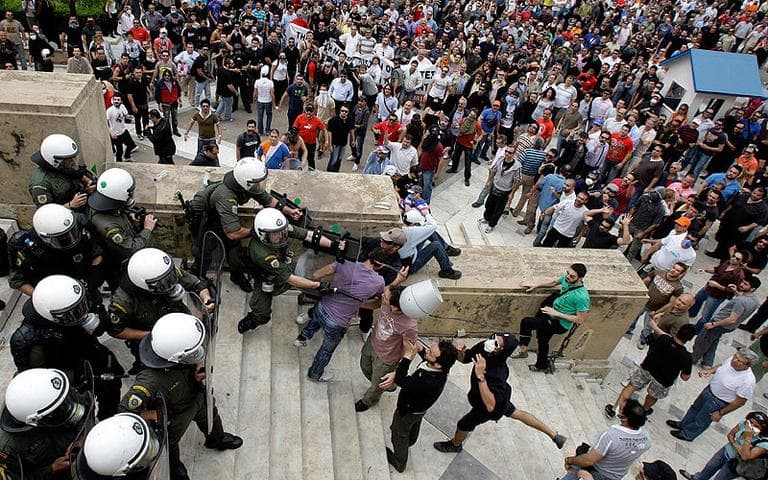 Protesters clash with riot police at the Greek Parliament in Athens on Wednesday. (AP)