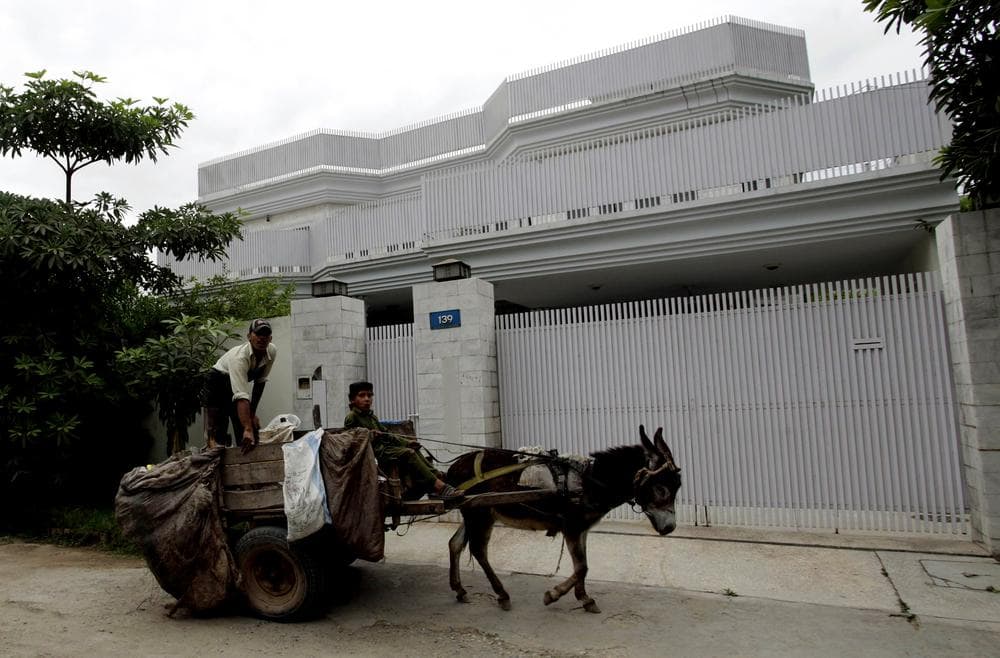 A donkey cart drives past a house, owned by the family of Times Square bombing suspect Faisal Shahzad, in Peshawar, Pakistan on Wednesday, May 5, 2010. (AP)