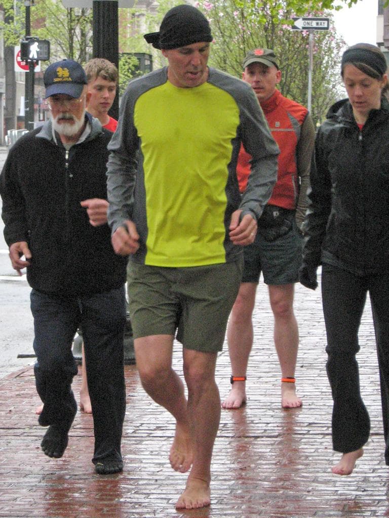 &quot;Born To Run&quot; author Christopher McDougall demonstrates barefoot running to a group in Boston.  (Karen Given/WBUR)