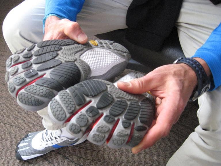 A runner displays the Vibram Five Fingers shoes. (Karen Given/WBUR)