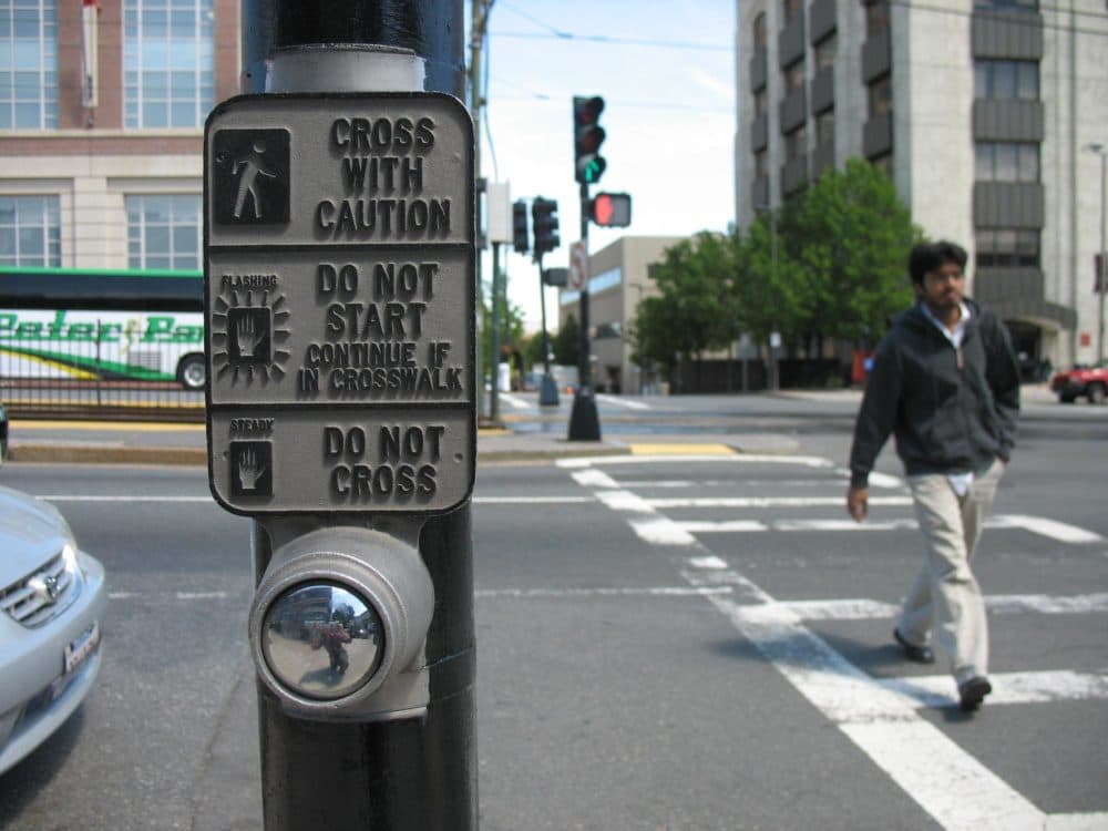 This crosswalk button, at the corner of Commonwealth Avenue and St. Paul Street, triggers a walk sign. A lot of buttons in Boston don't. (Adam Ragusea/WBUR)
