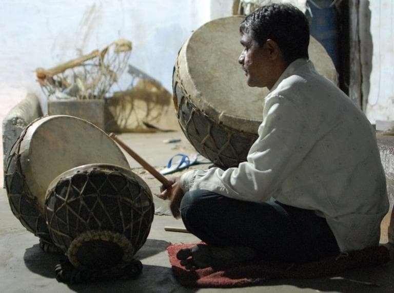 Sheru Mayuddin sits by his family&#039;s drum set in Ahmedabad, India. (Jill Ryan)
