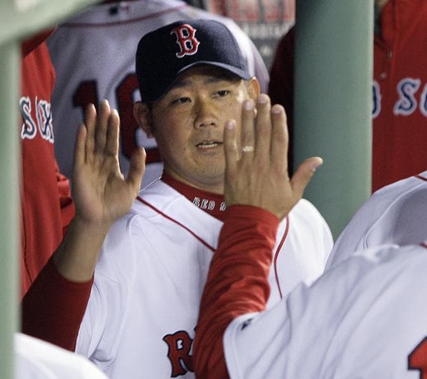 Boston starting pitcher Daisuke Matsuzaka receives high-fives in the dugout after the top of the seventh inning against Toronto in a game in Boston on Tuesday. (AP)