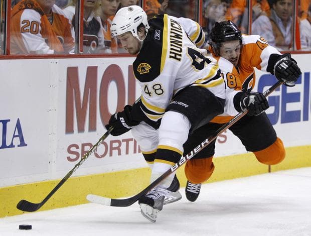 Boston's Matt Hunwick keeps the puck from Philadelphia's Danny Briere in the second period of Game 6 of a second-round playoff hockey series on Wednesday in Philadelphia. (AP)