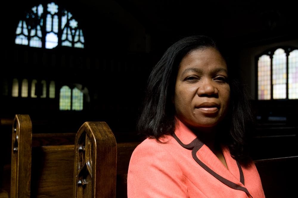 Jacqueline LaGuerre sits in the church where her husband is a pastor, Philadelphie Seventh Day Adventist Church, in Malden. (Jess Bidgood for WBUR)