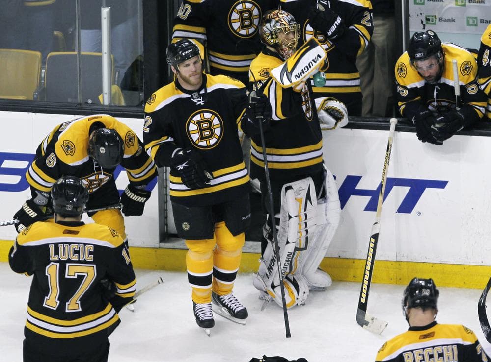 Bruins wait by their bench as the Flyers celebrate their 4-3 win in Game 7 of a second-round NHL playoff hockey series in Boston, Friday. (AP Photo/Charles Krupa)